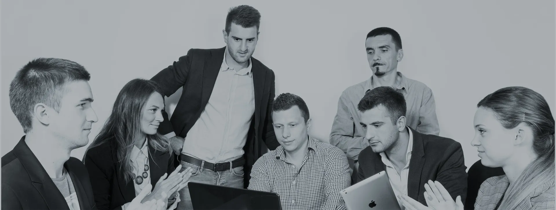 The Vibe Your Website crew of senior developers gathered around one laptop during a build session